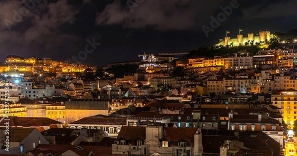 Obraz Panoramic, night view of the Alfama district in Lisbon with the illuminated S. Jorge Castle on the hill