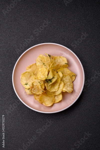 Obraz Crisps fried with salt, spices and garlic. Cooked potatoes