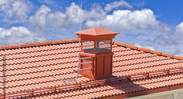 Fototapeta house with a roof from a red shingles with a pipe
