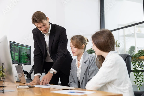 Fototapeta Colleagues collaborating on a project in a modern office