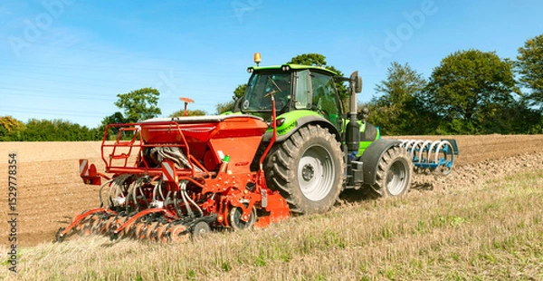 Fototapeta Tractor with seed drill, rotary harrow, and front packer tilling the field - 3592