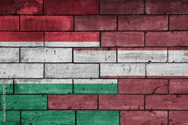 Fototapeta colourful painted big national flag of latvia and flag of hungary on a massive old brick wall background. concept