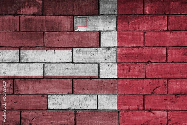Fototapeta colourful painted big national flag of malta and flag of latvia on a massive old brick wall background. concept