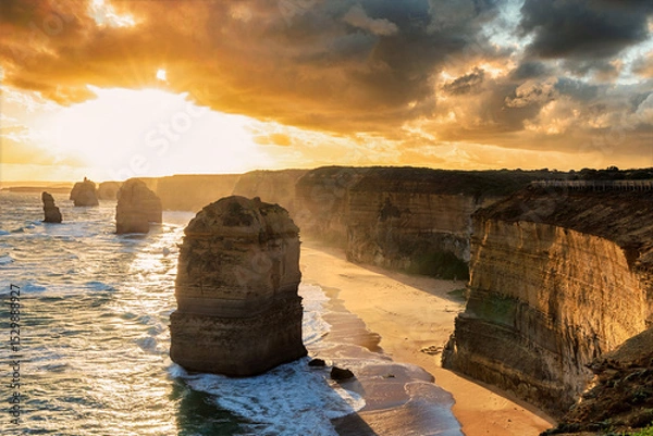 Fototapeta The shoreline with of the 12 Apostles in Victoria, Australia at a golden hour sunset
