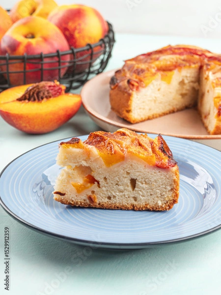 Fototapeta Piece of nectarine peach cake on turquoise table
