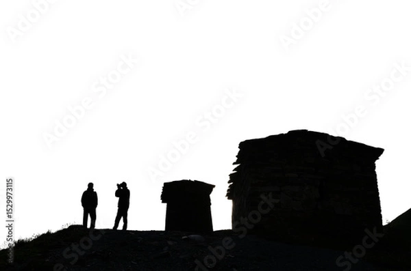 Fototapeta silhouettes of ancient stone towers and silhouettes of people against the sky historical architecture of the Caucasus transparent background