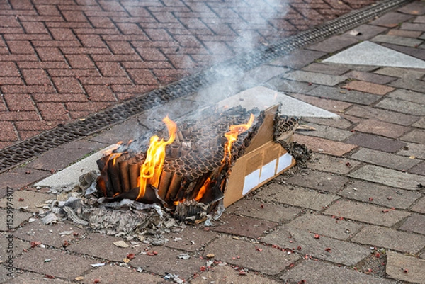 Obraz box of burnt out fireworks is outside on the street