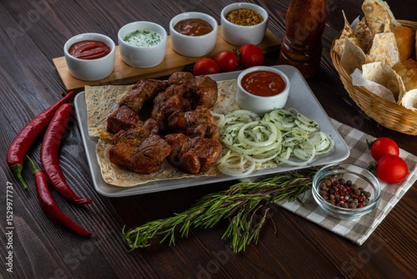 Fototapeta Shashlik with sauces and fresh bread on wooden background