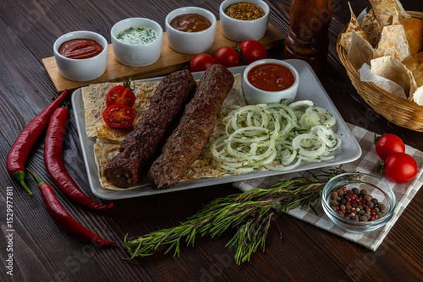 Fototapeta Beef kebab with sauces on wooden background