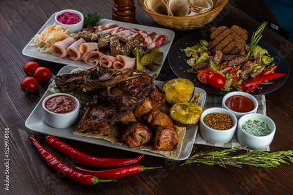 Fototapeta Meat set, salad, bacon on wooden background