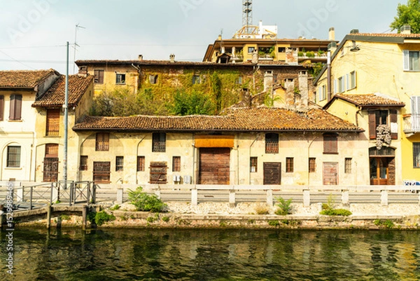 Obraz Old rustic house with tiled roof by canal, Navigli district, Milan