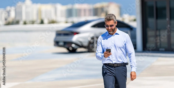 Obraz Business man chat on phone outdoor. Businessman chatting on phone. Businessman using smartphone. Handsome businessman chatting online. Businessman walking. Corporate business. Copy space banner