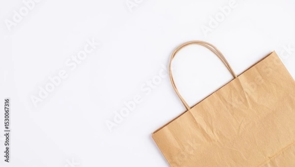 Fototapeta Brown Paper Shopping Bag on White Background - Minimalist Retail Mockup, Eco-Friendly Packaging, Blank Template for Branding and Design