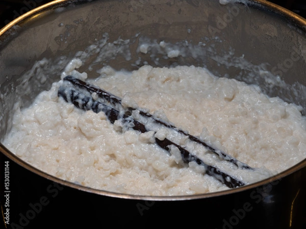 Obraz Close-up of creamy Swedish rice pudding with a whole cinnamon stick in a pot, ready to serve for dessert or breakfast