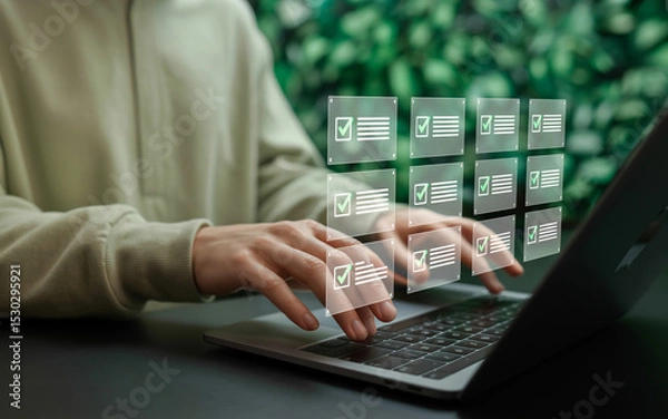 Fototapeta Woman using laptop with digital checklist interface for task management and productivity