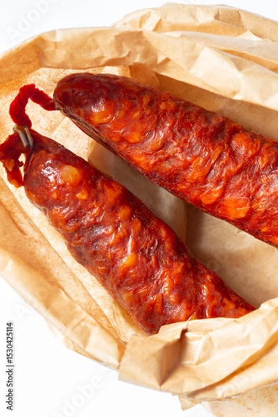 Obraz Spanish Chorizo spicy sausage in a brown paper bag background. Environmetally friendly eco biodegradable packaging concept.