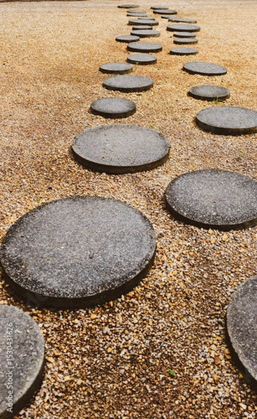 Fototapeta Stone Path Journey: A serene scene of a stone path leading into the distance, evoking a sense of adventure and contemplation, each step a testament to mindful progress.