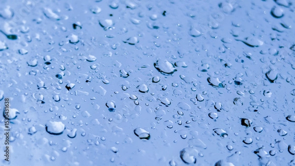 Fototapeta Gentle Drops: A serene macro shot capturing the delicate beauty of water droplets clinging to a smooth surface, reflecting light and texture