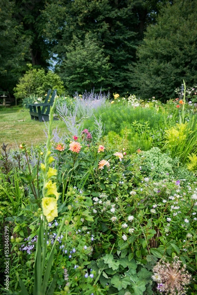 Obraz Lush Summer Garden with Wildflowers and Green Bench