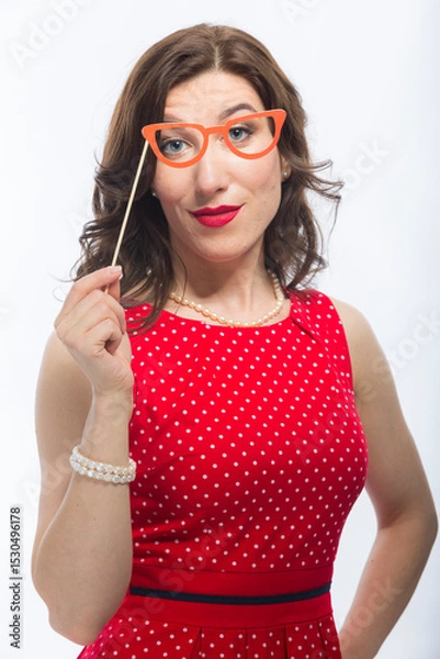 Fototapeta Portrait of Surprised Caucasian Brunette Woman With Artistic Spectacles In Front Of Face.Against White.