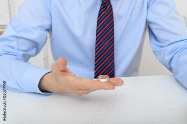 Obraz a man holds a wedding ring in his hand, engagement and relationships