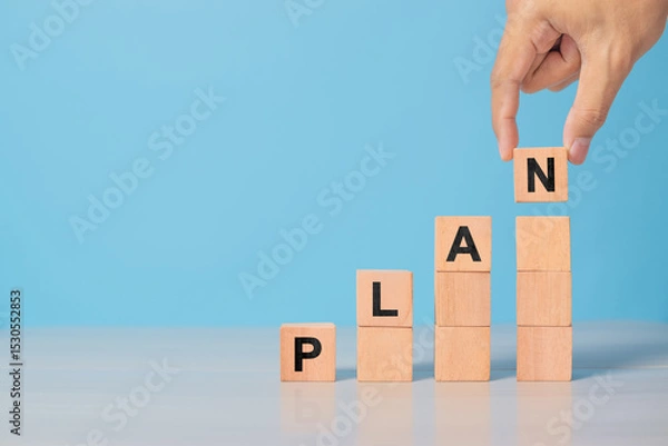 Obraz Hand hold wooden cube with PLAN word. The concept of planning in business