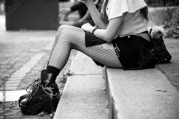 Obraz Closeup of legs of gothic girl wearing sexy stockings and black boots standing in the street