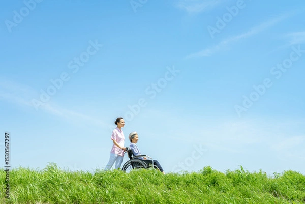 Obraz 車椅子を押す介護士