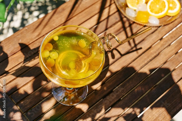 Fototapeta Summer refreshing orange soda drink on the table in the garden. Iced lemonade with orange slices.