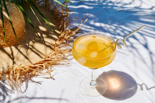 Fototapeta Summer refreshing orange soda drink on the table in the garden. Iced lemonade with orange slices.