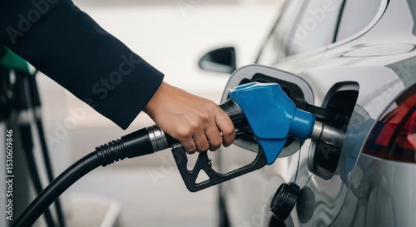 Fototapeta Refueling action at a gas station city location automotive content urban environment close-up viewpoint energy concept for efficient travel
