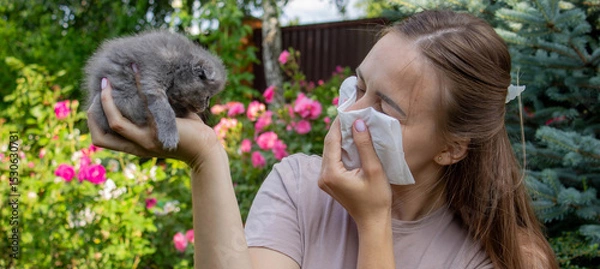 Fototapeta Woman Sneezing from Cat Allergy in Garden