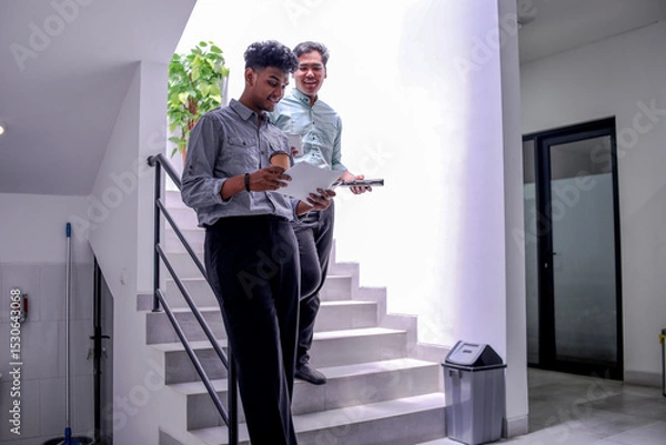 Obraz Professional Partners Sharing Ideas While Standing on Stairs