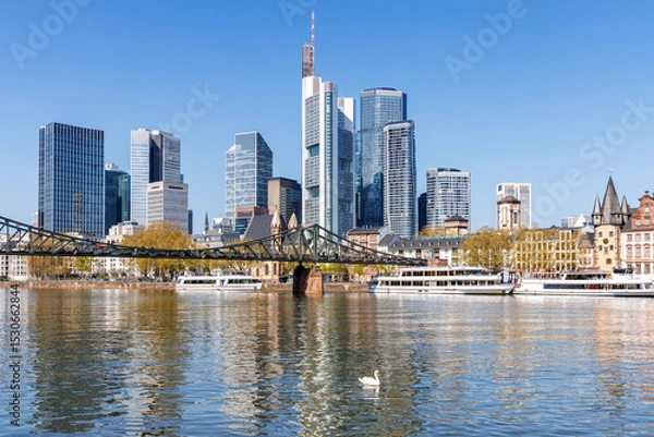 Fototapeta Frankfurt skyline skyscrapers with banks on River Main with excursion boats in Frankfurt, Germany