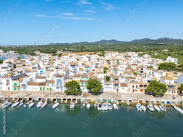 Fototapeta Portocolom fishing village on Mallorca island aerial view from above with boats holiday by the sea in Spain