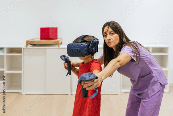 Fototapeta Child wearing virtual reality glasses playing with doctor assisting