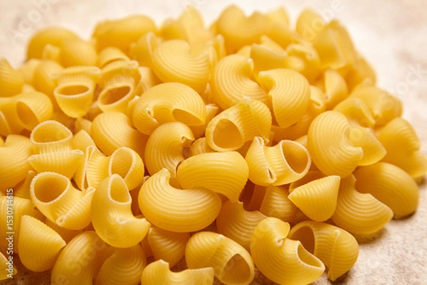 Fototapeta Heap of Pipe Rigate Pasta on Textured Beige Background