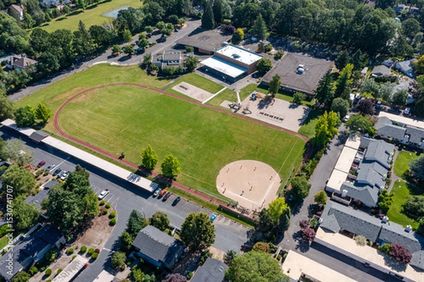 Obraz Aerial drone picture of a beautiful residential apartment complex in Cedar Mill, Portland, OR, captured at morning. Footage shows green courtyards, swimming pool, parking lots and housing buildings	
