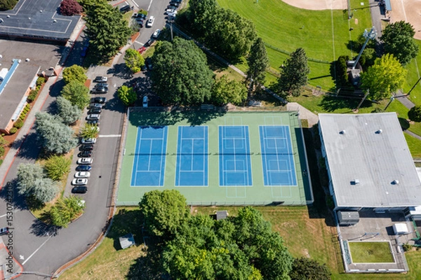 Obraz High resolution aerial drone picture of outdoor tennis courts and green fields near a high school in Cedar Mill, Portland, Oregon, captured on a clear summer day	
