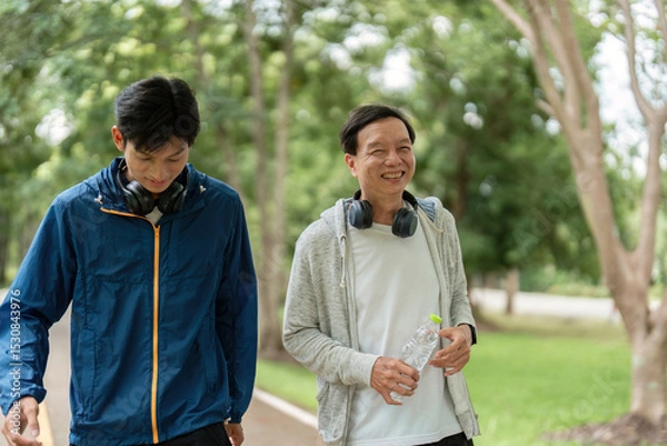 Fototapeta Father and Son Enjoying a Wellness Walk and Sharing Smiles