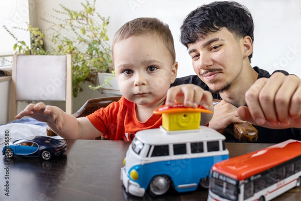 Fototapeta  Two Jewish Half-brothers - 2,5 and 17 year old are playing with model cars.
