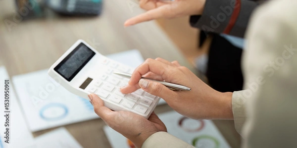 Fototapeta Financial Analysis and Calculation. Professionals using calculator for project budgeting.