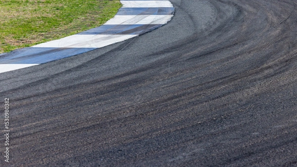 Fototapeta Car tire mark on race track, Abstract black car tire mark on race track, Abstract texture background car tire mark skid mark on asphalt circuit, Tire track on road race speed track circuit.