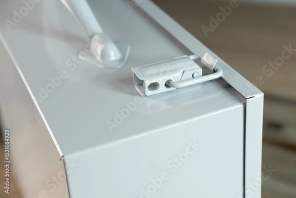 Obraz Gray metal case with transport handle, perfect for storage and organization, Industrial-style metal case with handle, ideal for tools, equipment, or supplies, portable safety