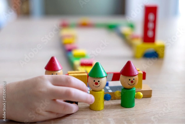 Obraz Child playing with wooden toys, play time, Colorful blocks and figures on table. Early education, fine motor skills concept