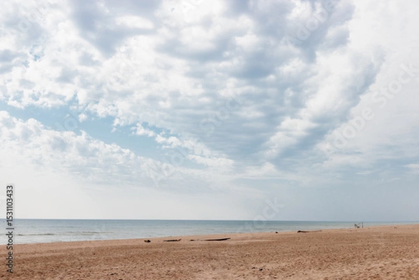 Fototapeta The clouds over Lake Michigan and Kohler-Andrae State Park, Sheboygan, Wisconsin, angle southward to the distant horizon