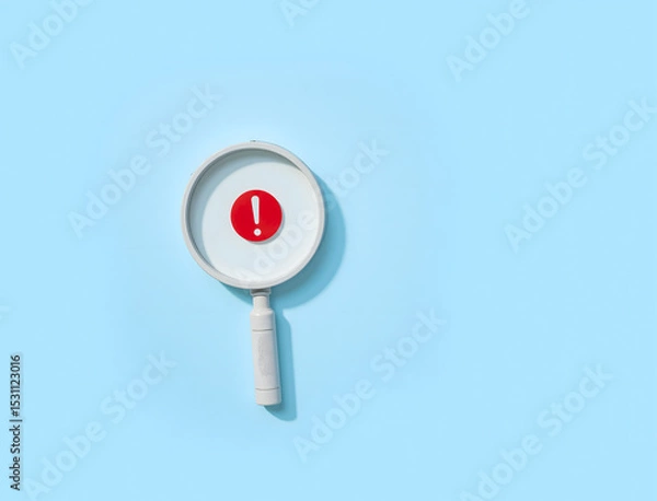 Fototapeta Magnifying Glass with Red Exclamation Mark on Blue Background