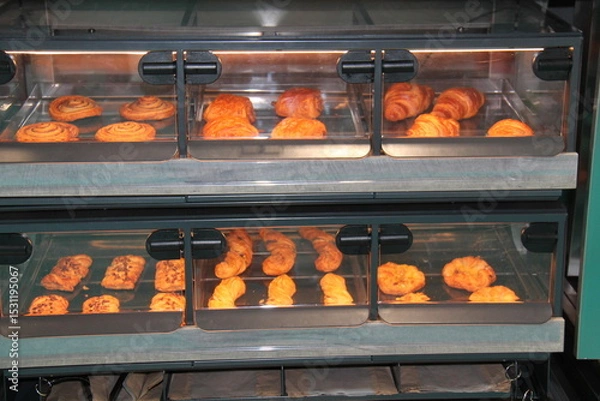 Obraz Fresh Pastries Baking in a Glass Fronted Oven.