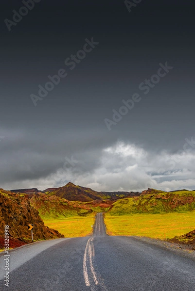 Fototapeta Cover page with a paved road, Ring road, through rough and colorful Icelandic landscape, Iceland, summer, dramatic scene, copy space