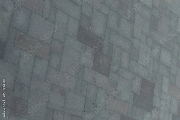 Fototapeta Perfect gray paving slabs. Road surface from blocks of different sizes. Gray geometric background.